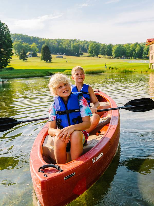 Two kids in a canoe at The Highlands