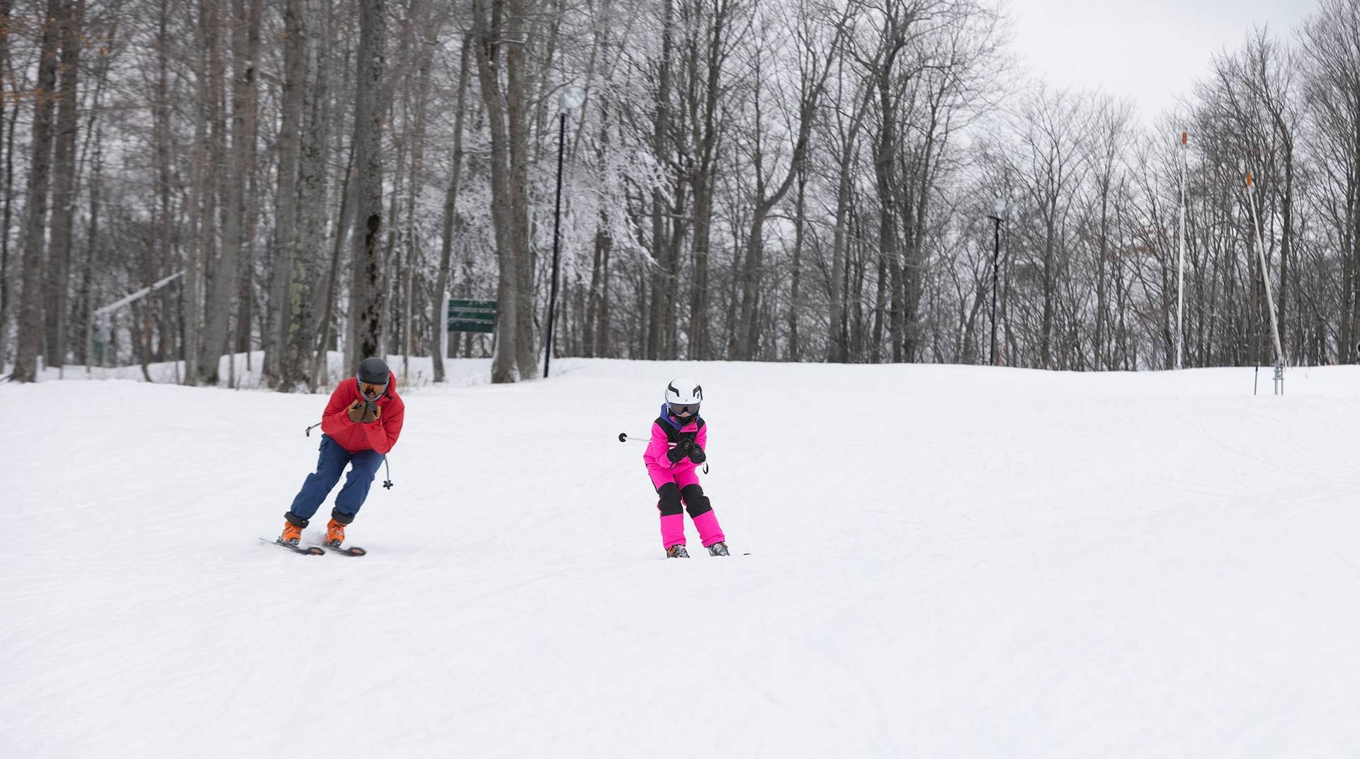A kid and a snowsports instructor at The Highlands