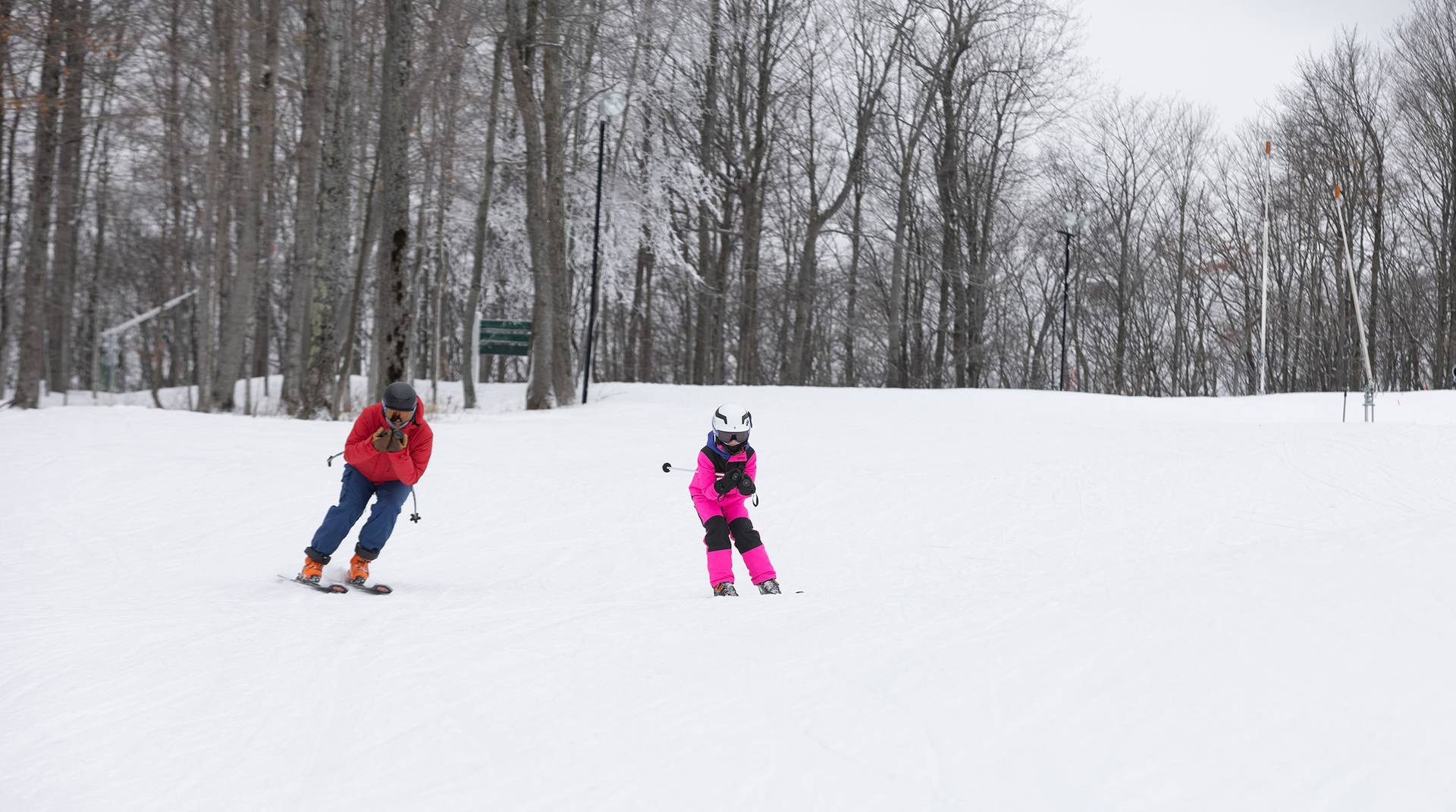 A kid and a snowsports instructor at The Highlands