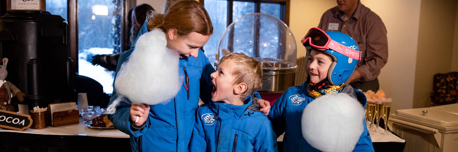 Three kids posing and smiling with cotton candy at The Highlands