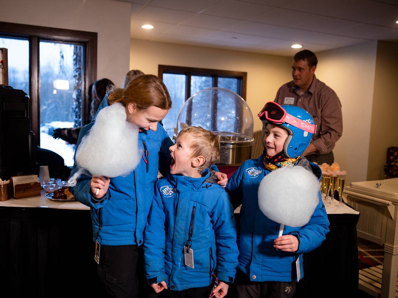 Three kids posing and smiling with cotton candy at The Highlands