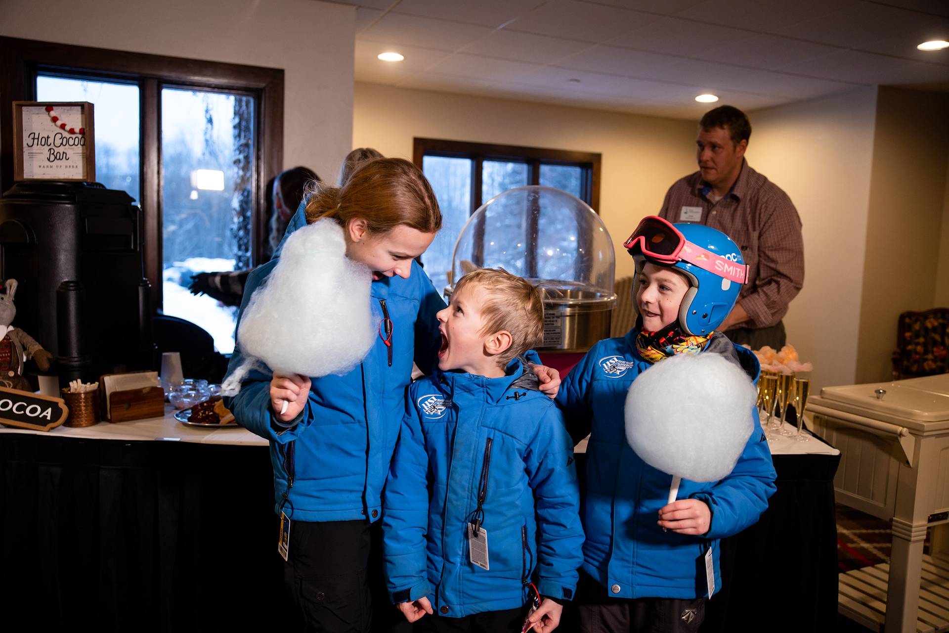 Three kids posing and smiling with cotton candy at The Highlands