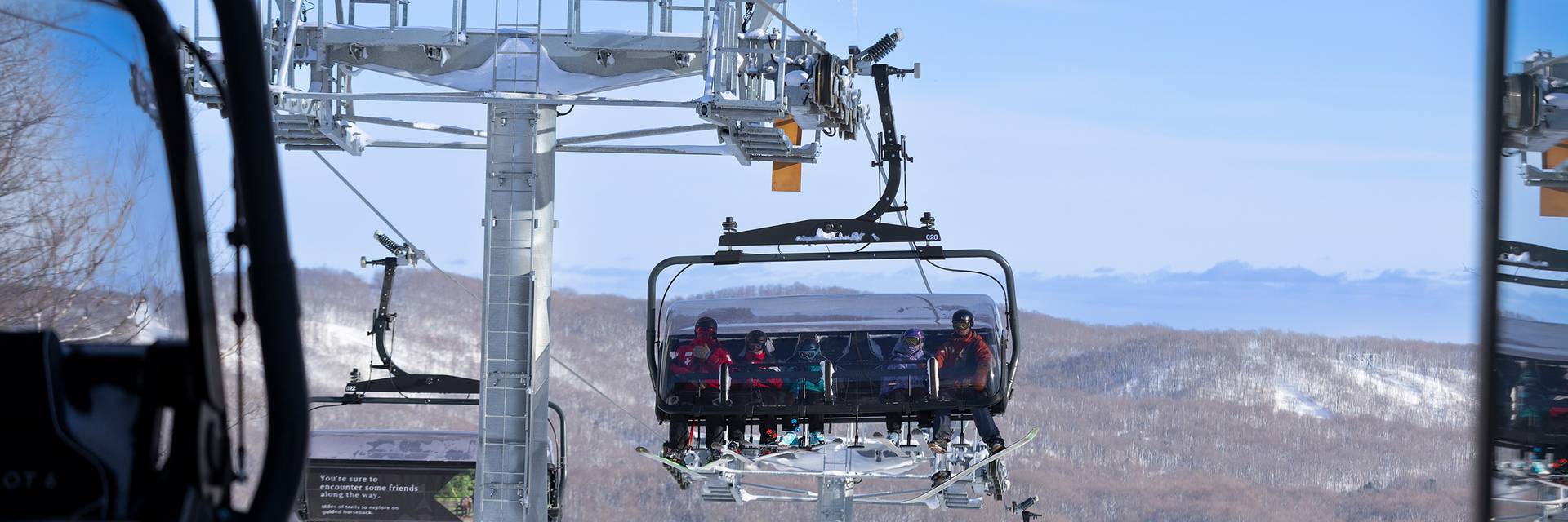 A group on the Camelot 6 ski lift at The Highlands