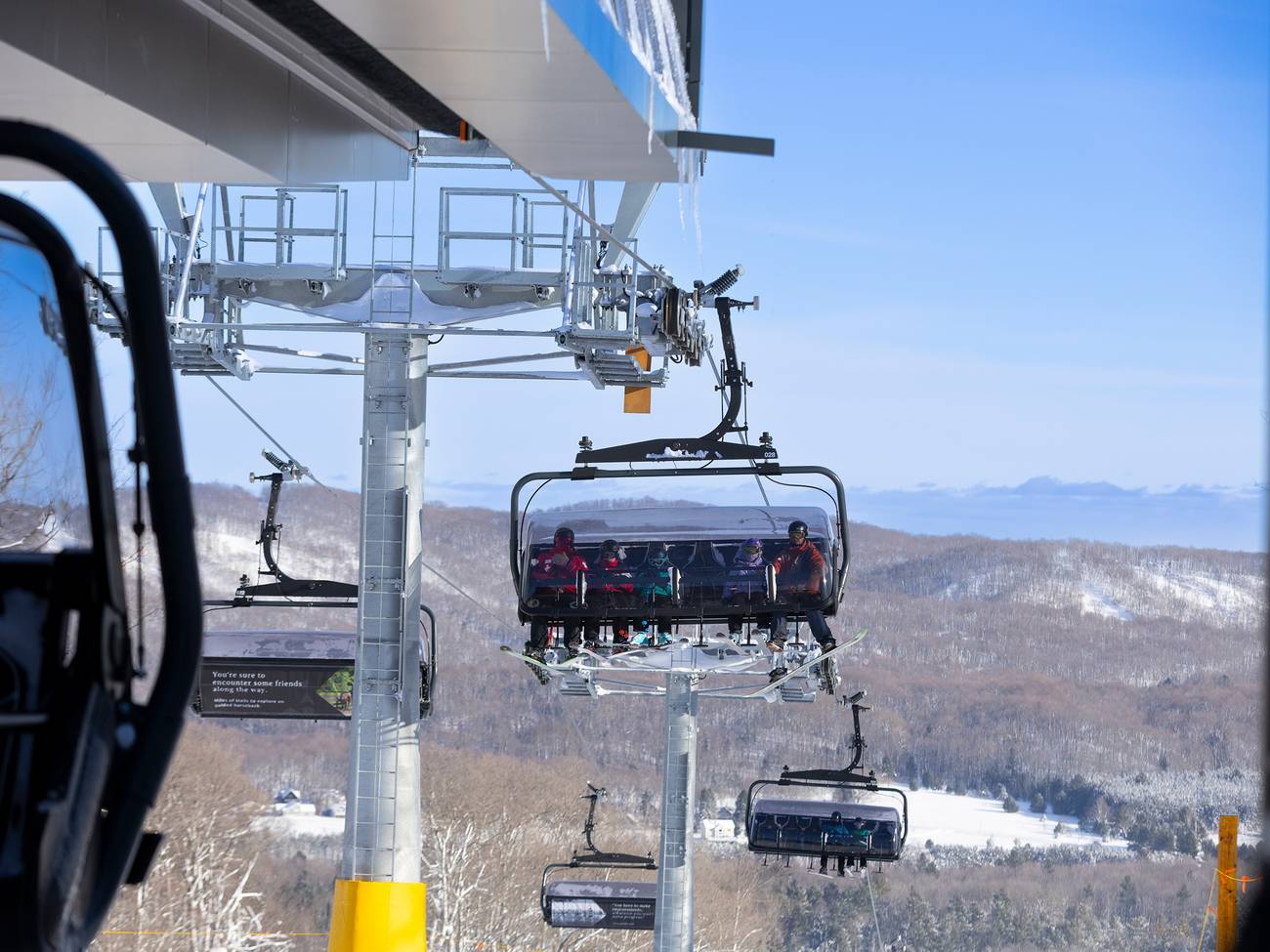A group on the Camelot 6 ski lift at The Highlands