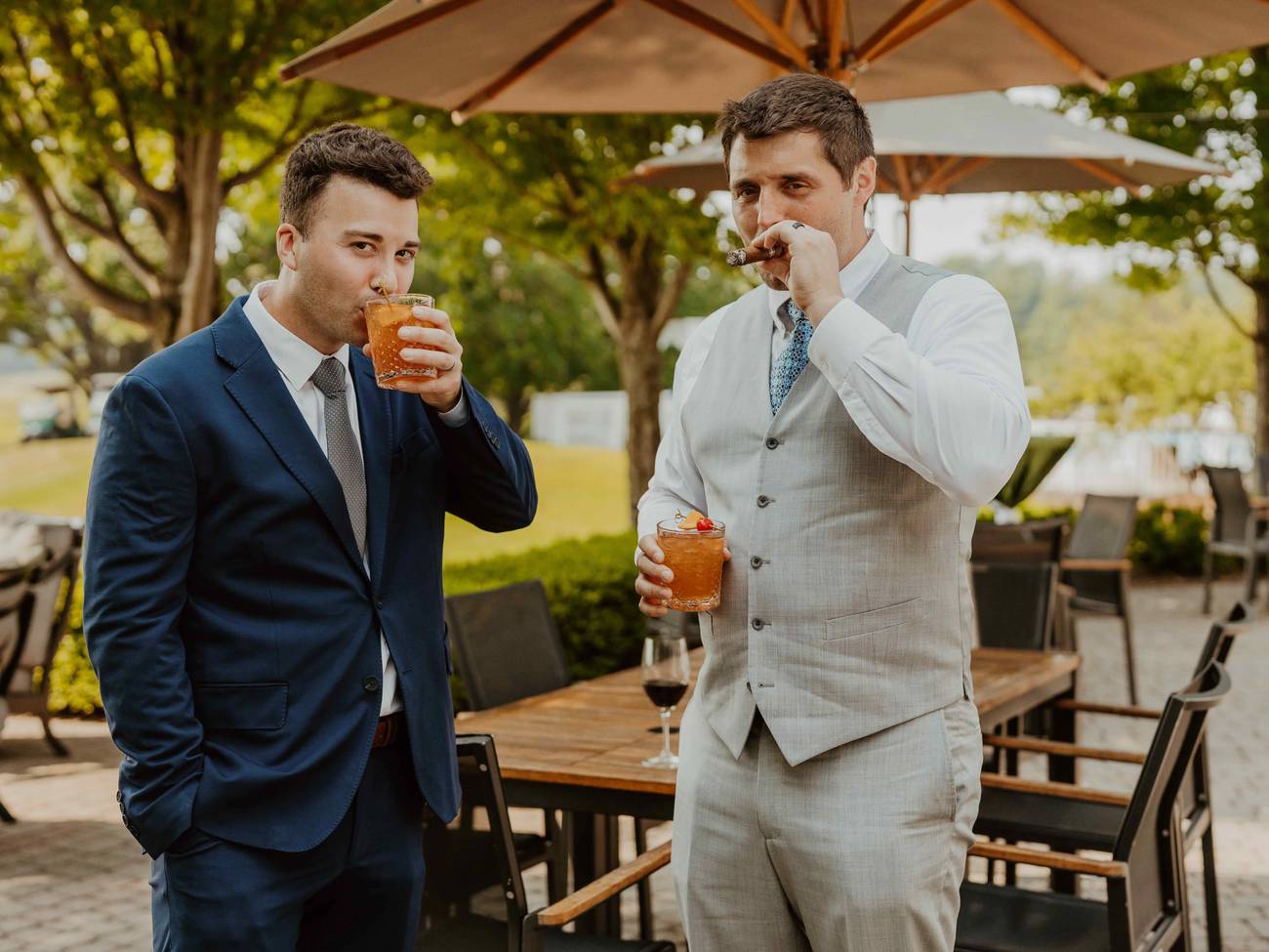 Two men holding cocktails