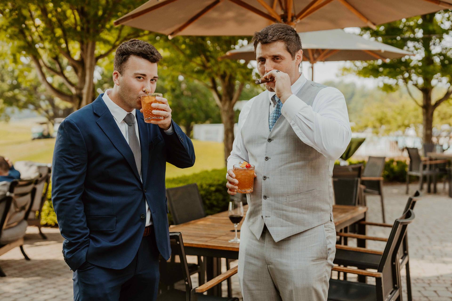 Two men holding cocktails