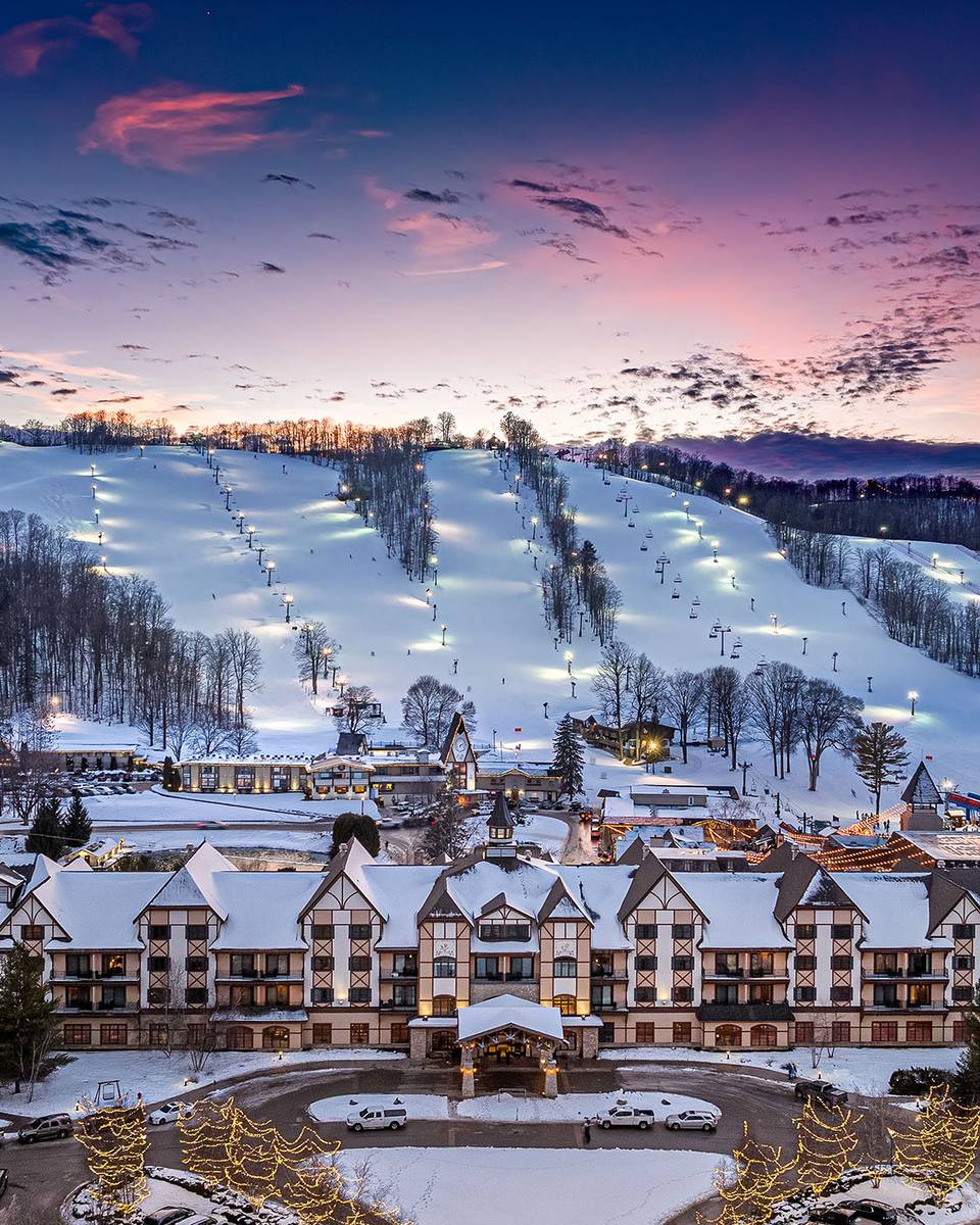 A drone shot of the Grand Lodge during a winter sunset at Boyne Mountain