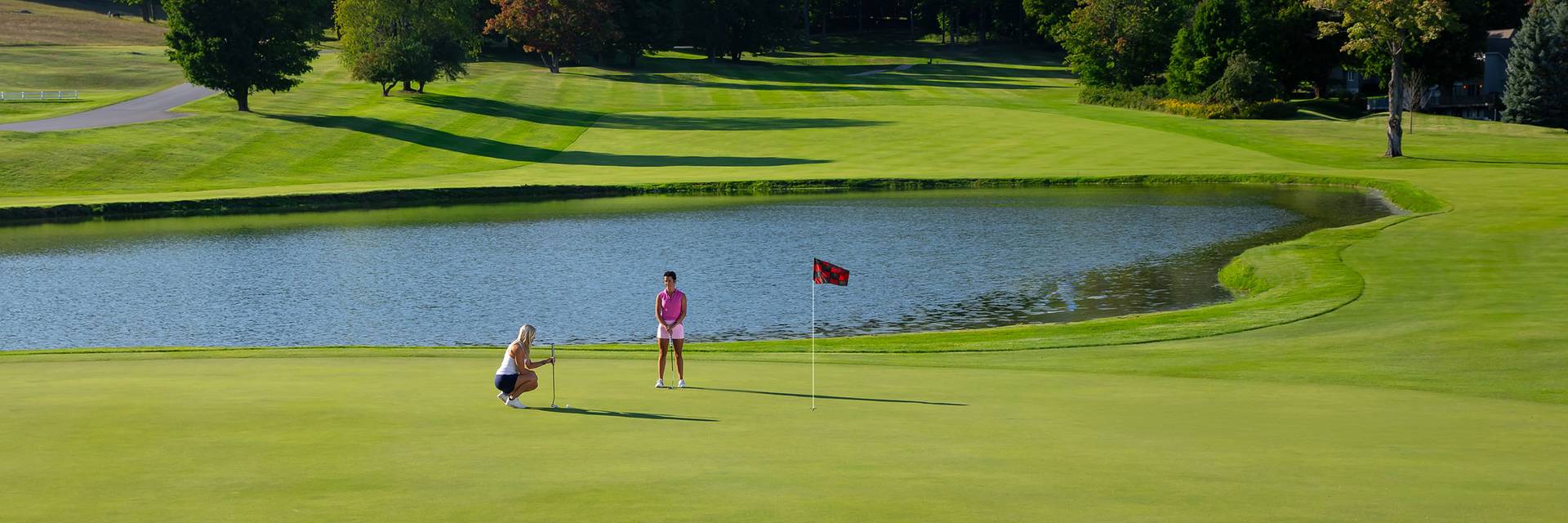 Two woman golfing at The Highlands