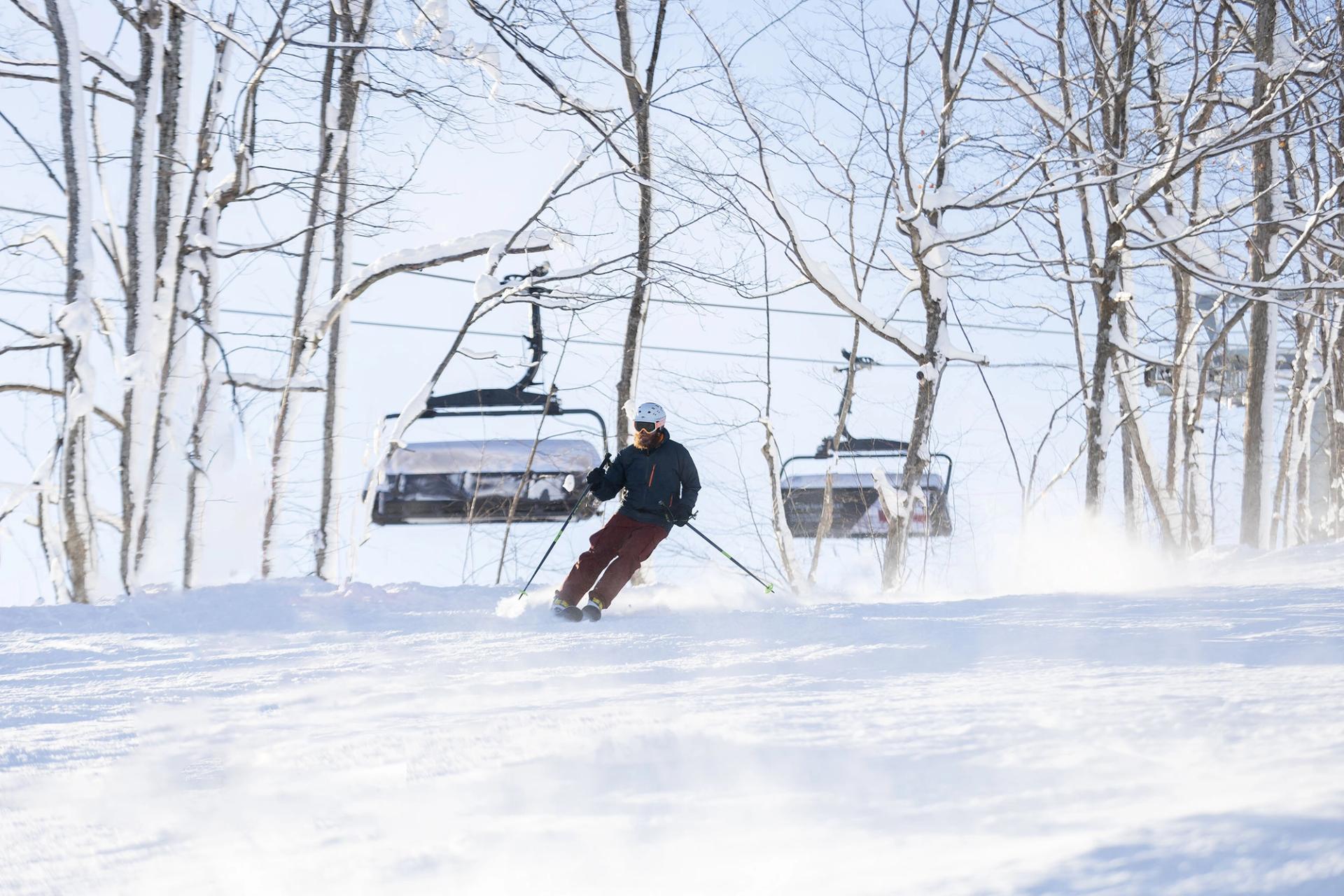 A skier skiing near Camelot 6 at The Highlands