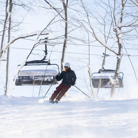 A skier skiing near Camelot 6 at The Highlands