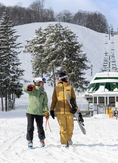 Two women walking from the Heather chairlift