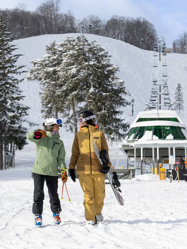Two women walking from the Heather chairlift