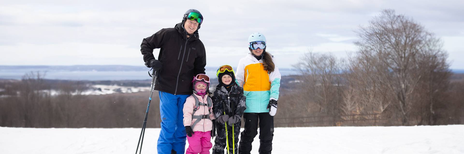 a family in ski gear posing at The Highlands