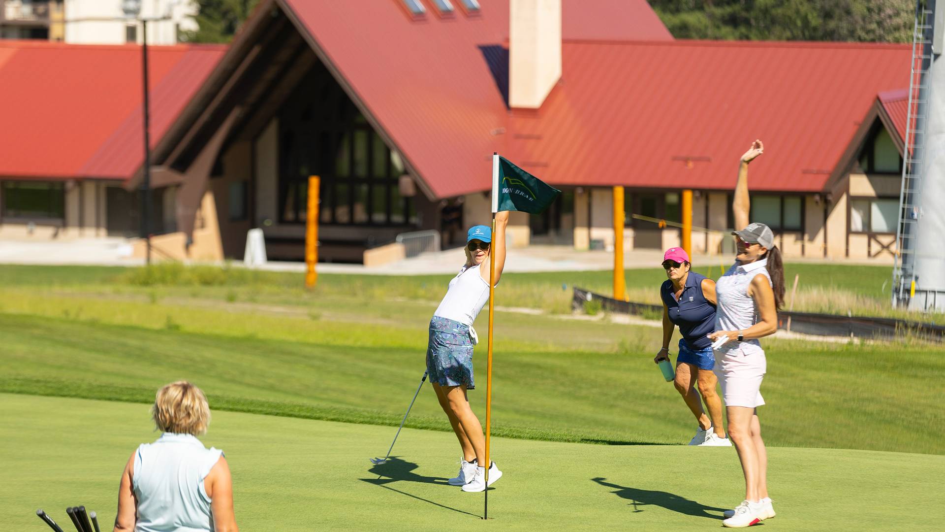 A group o women cheering while golfing Doon Brae
