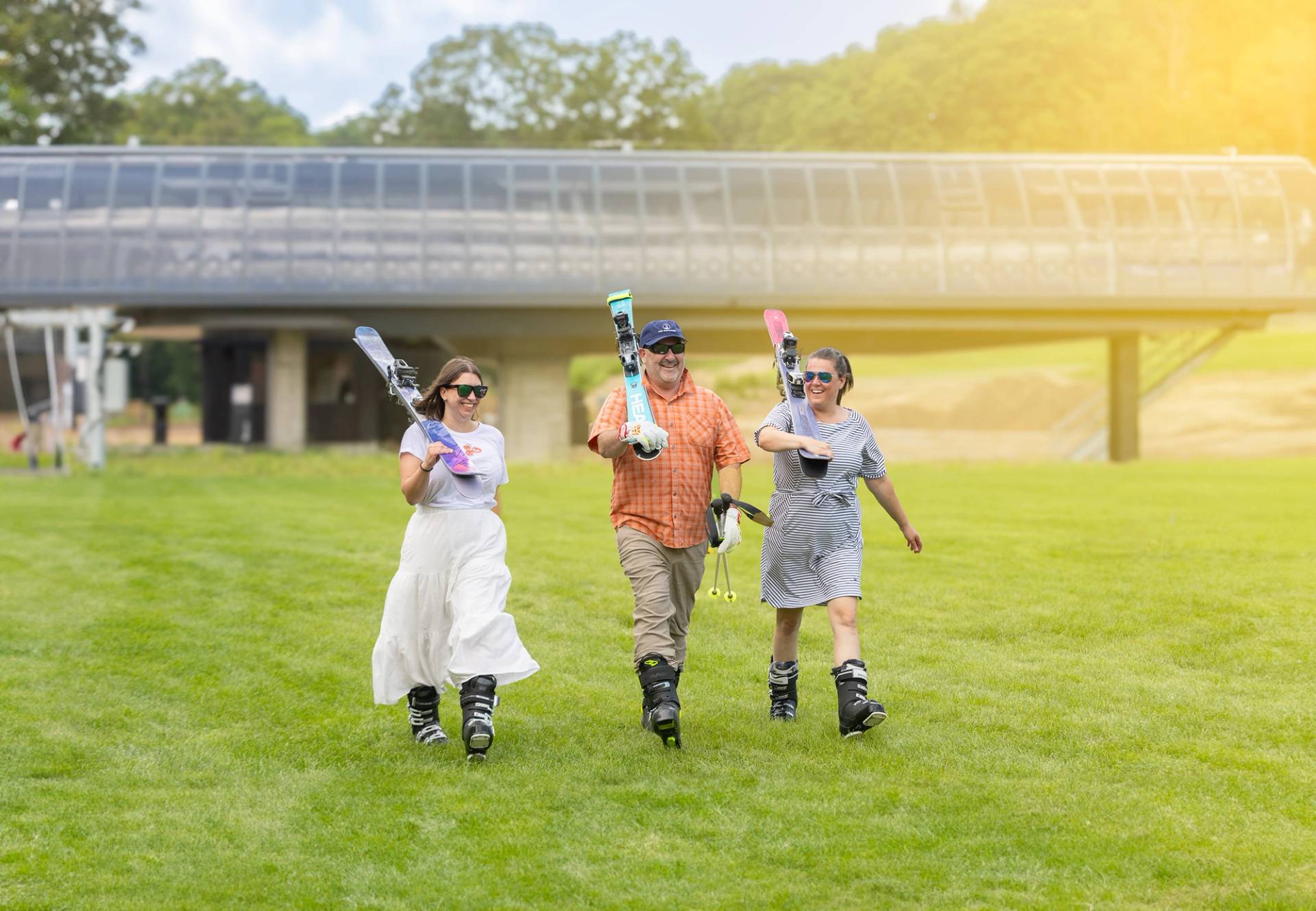 A group of people carrying skis in summer