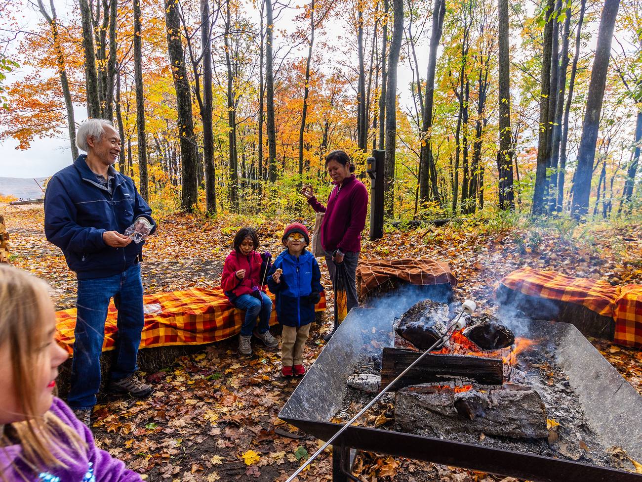 A group enjoying a bonfire during Harvest Fest at The Highlands