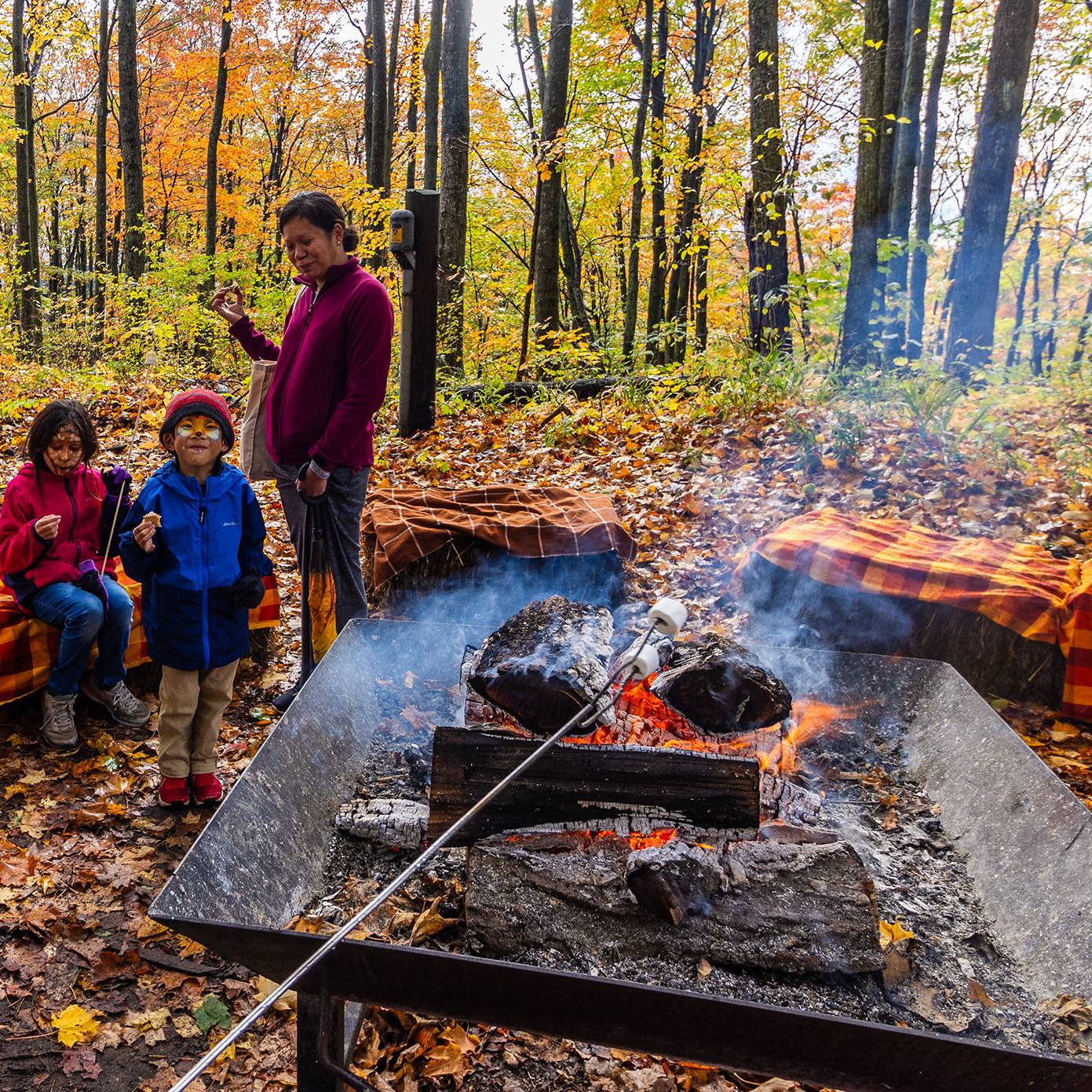 A group enjoying a bonfire during Harvest Fest at The Highlands