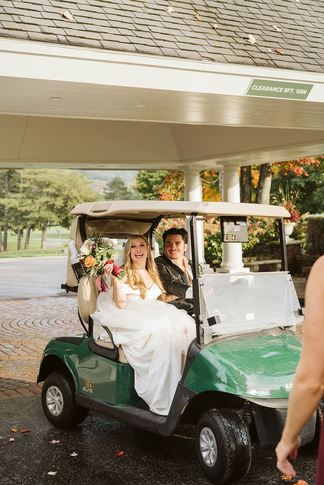 The bride and groom on a golf cart at The Highlands