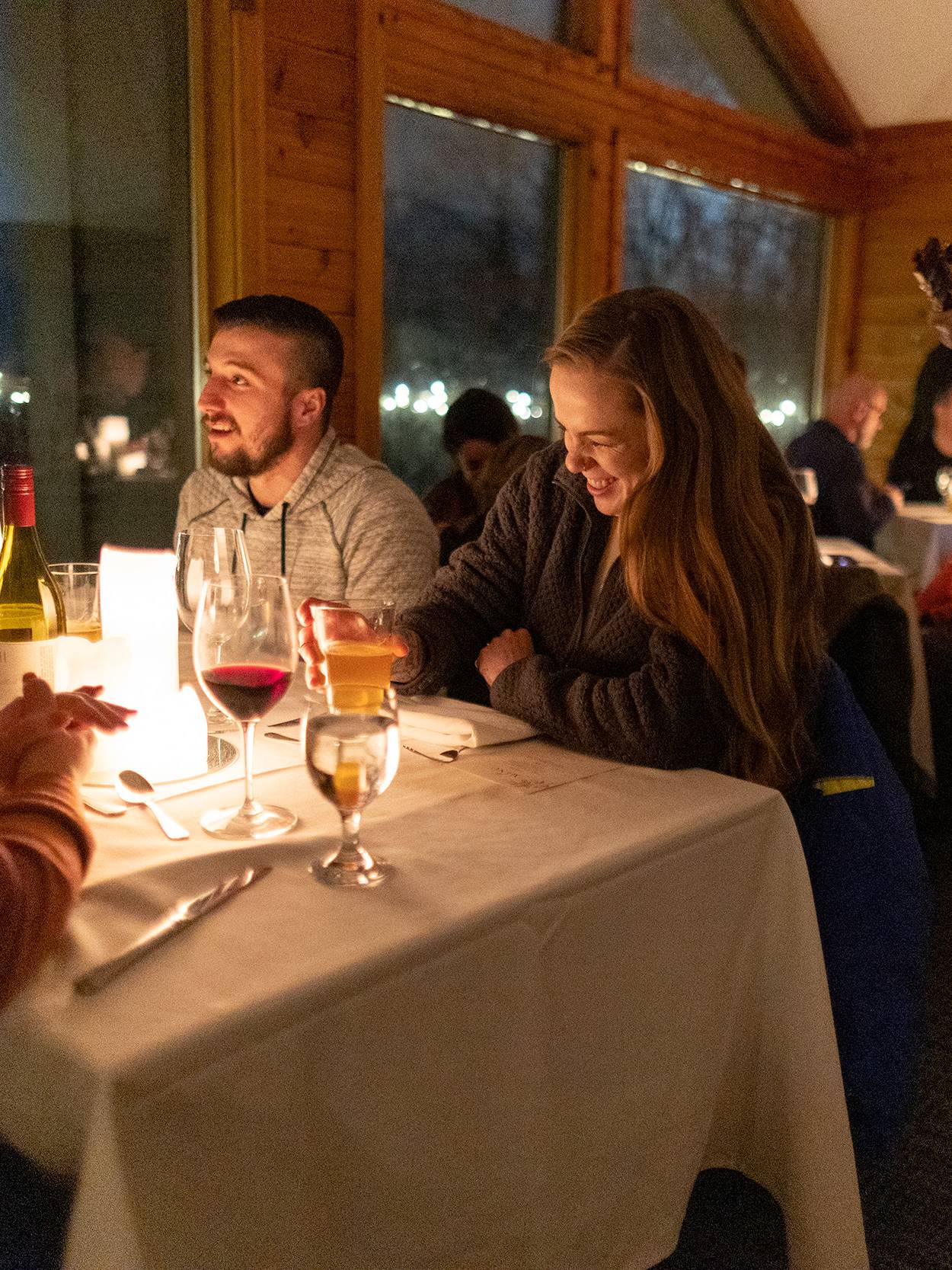 A couple smiling during the Aonach Mor Moonlight Dinner at The Highlands