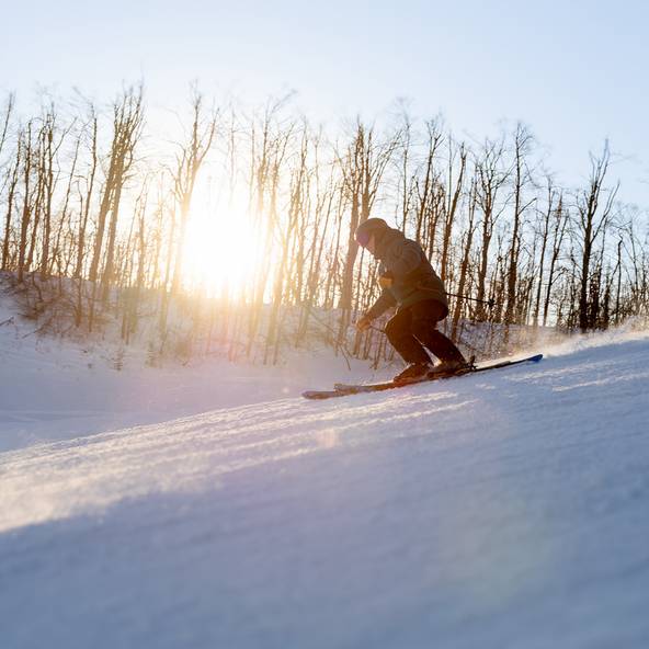 A skier during sunset at The Highlands