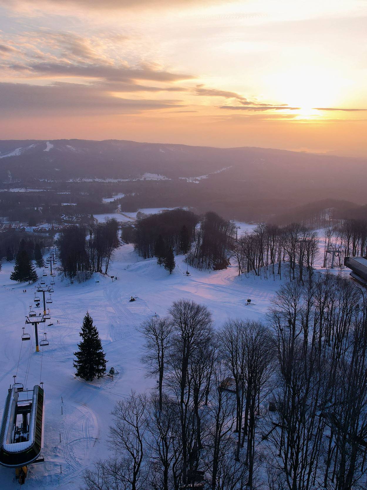 A group of kids eating waffles at The Highlands waffle cabin A sunrise over The Highlands ski slopes