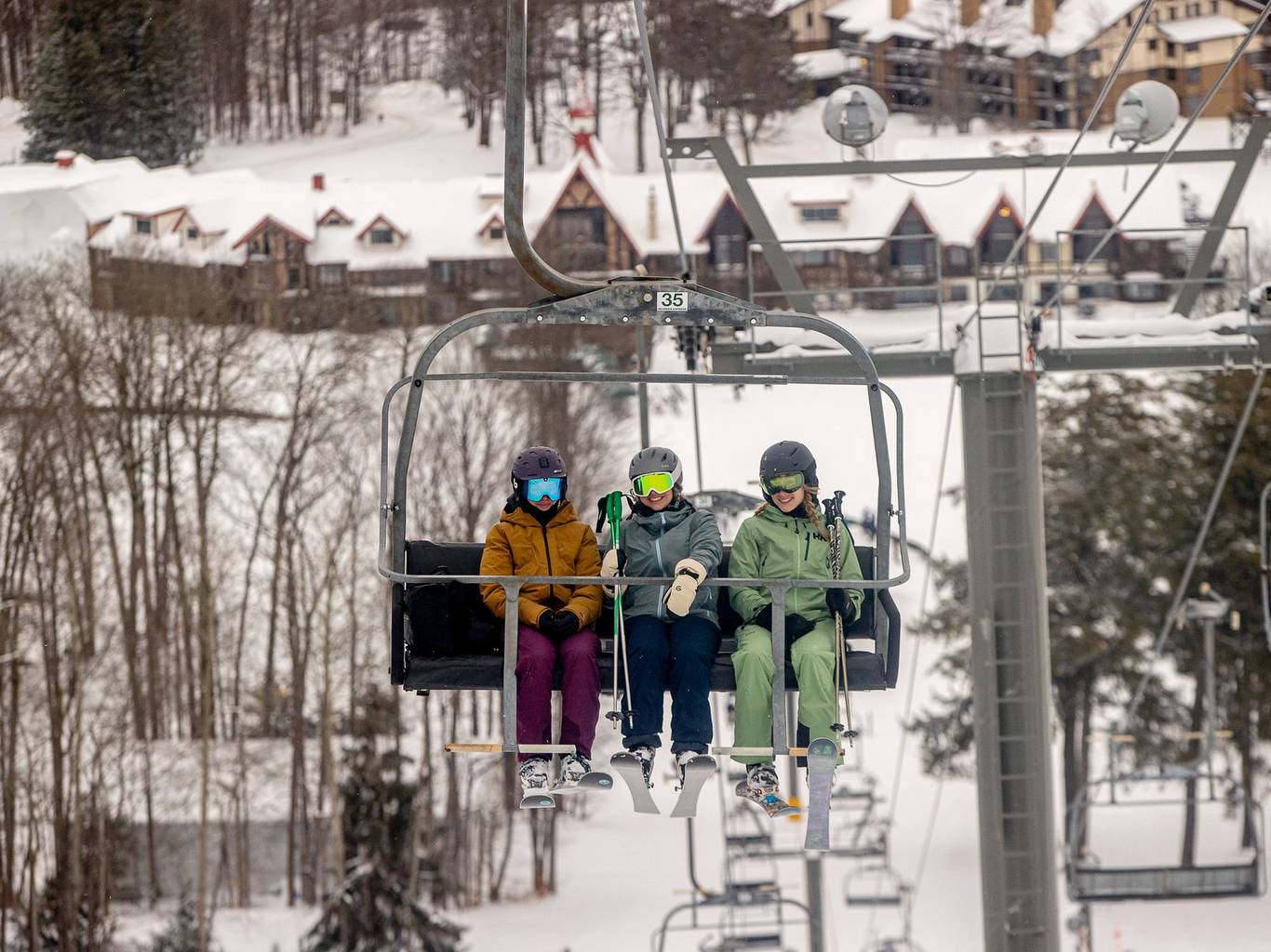 A man and child in ski gear posing at The Highlands