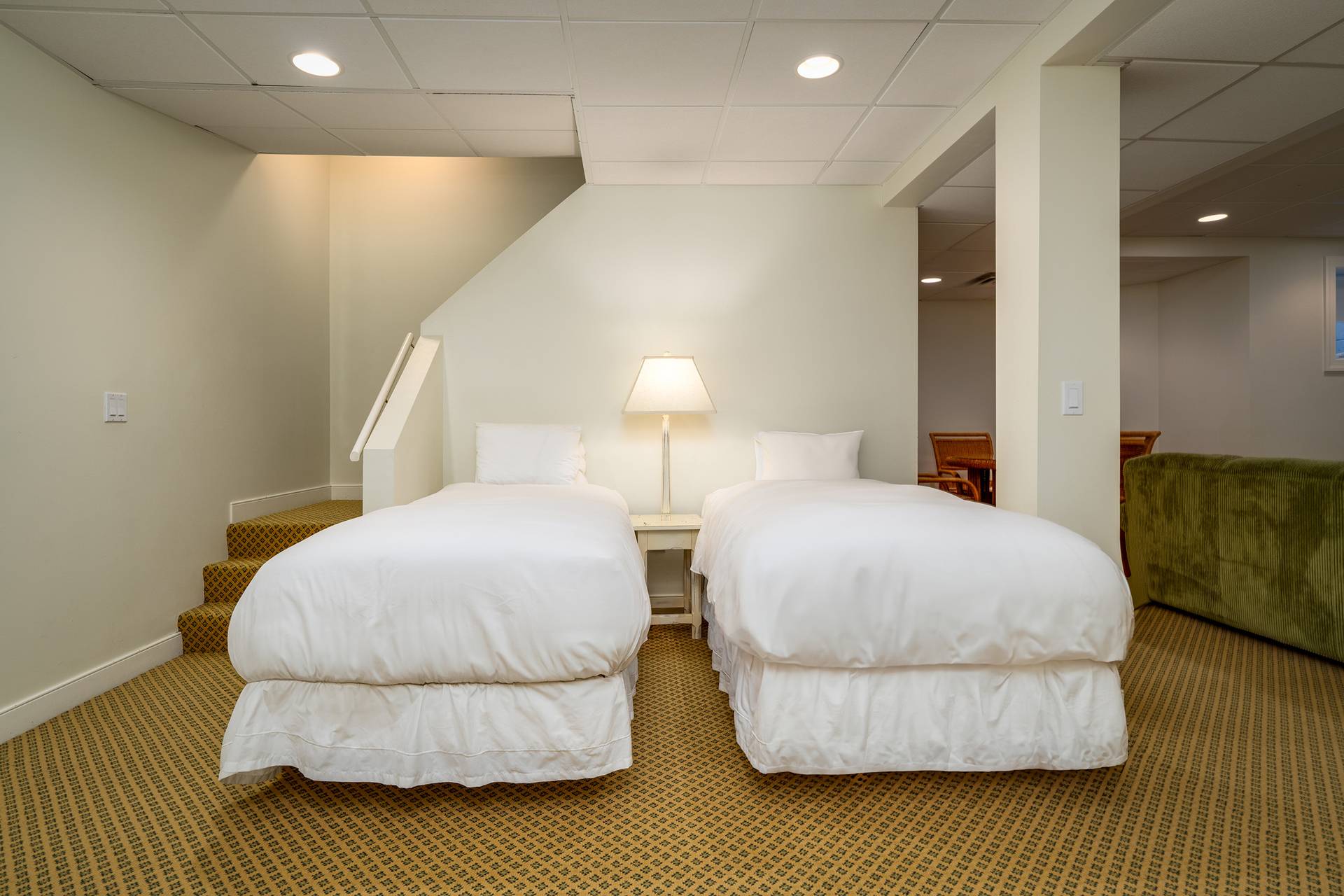 Two twin beds in basement living room in Ross Cottage