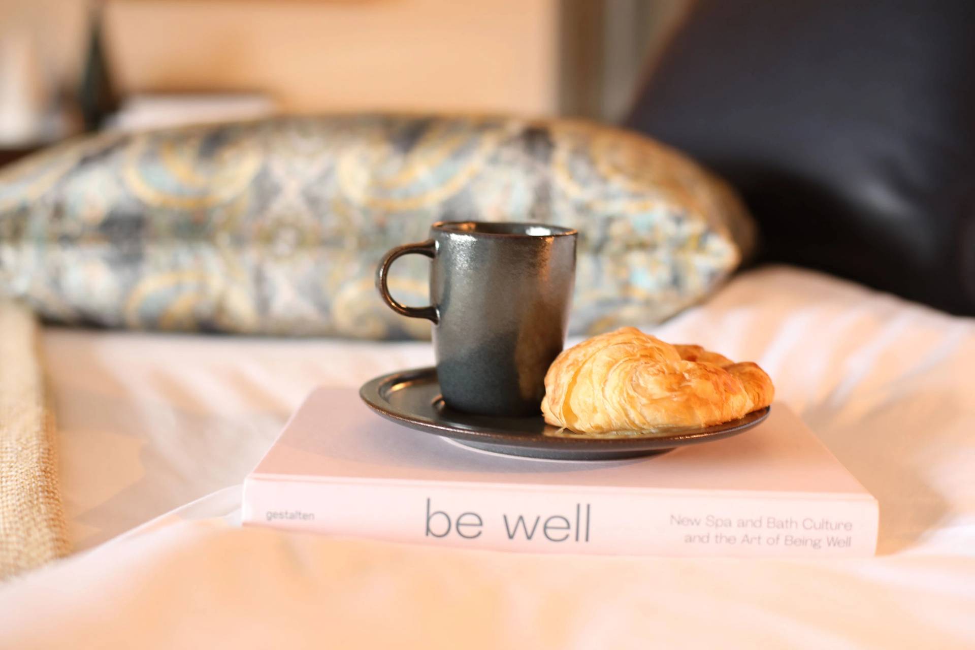 Main lodge breakfast and a book on a bed