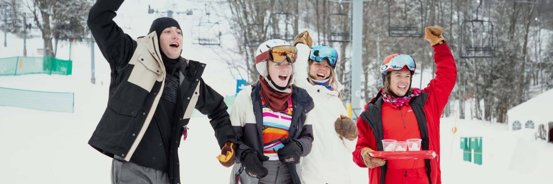 A group cheering in snow gear