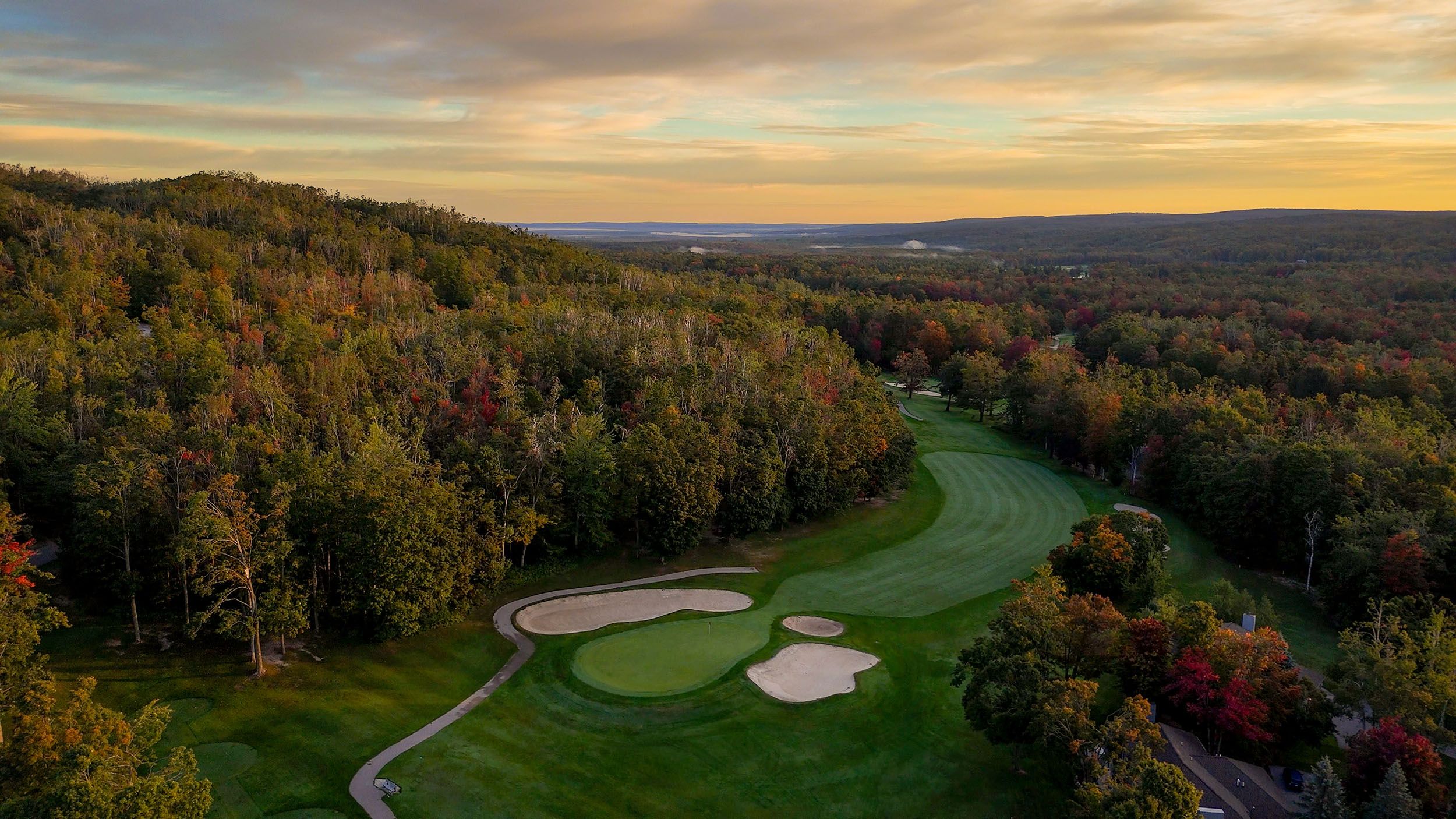 Drone shot of sunrise over the golf courses