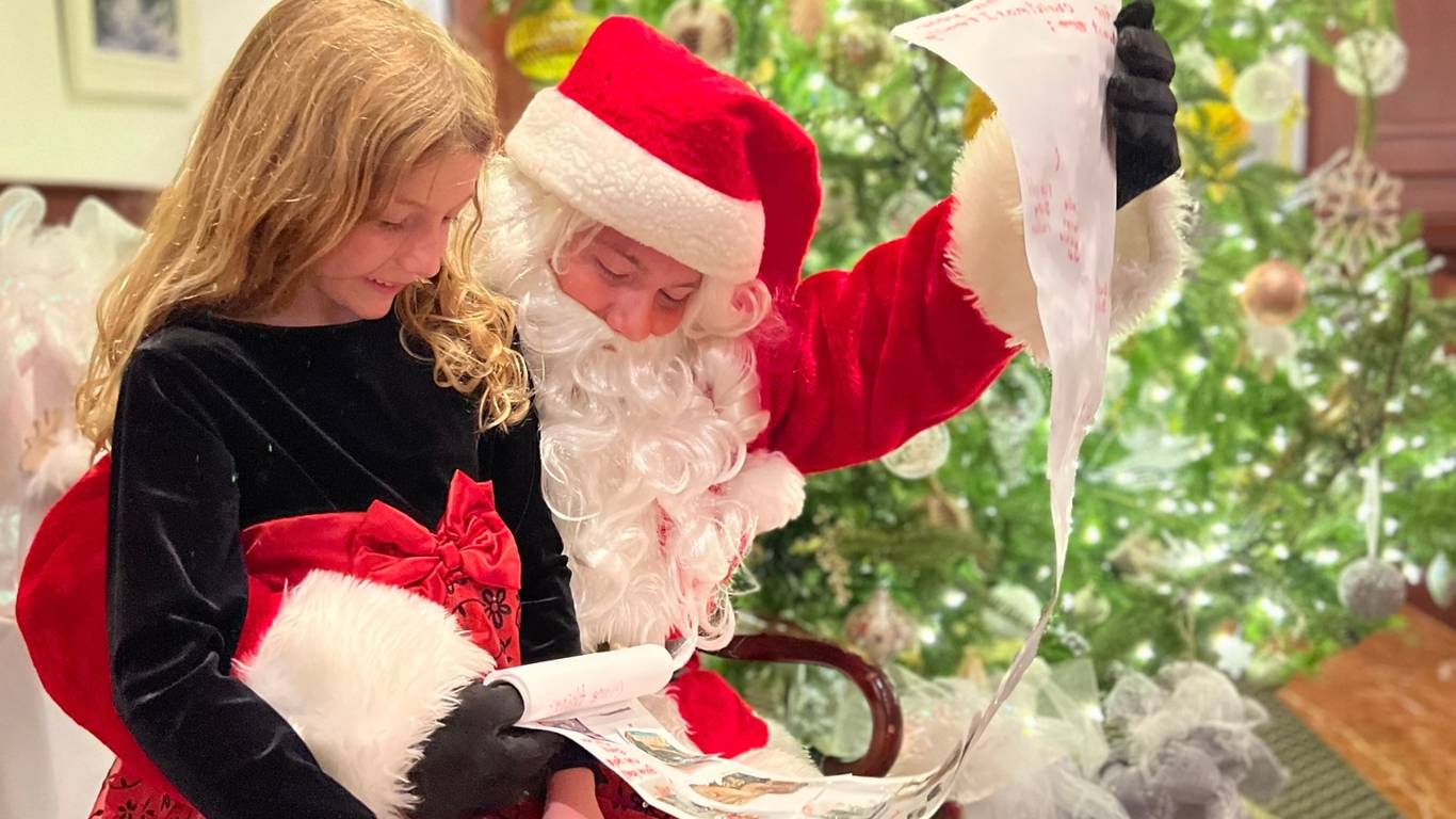 A little girl sitting on Santa's lap