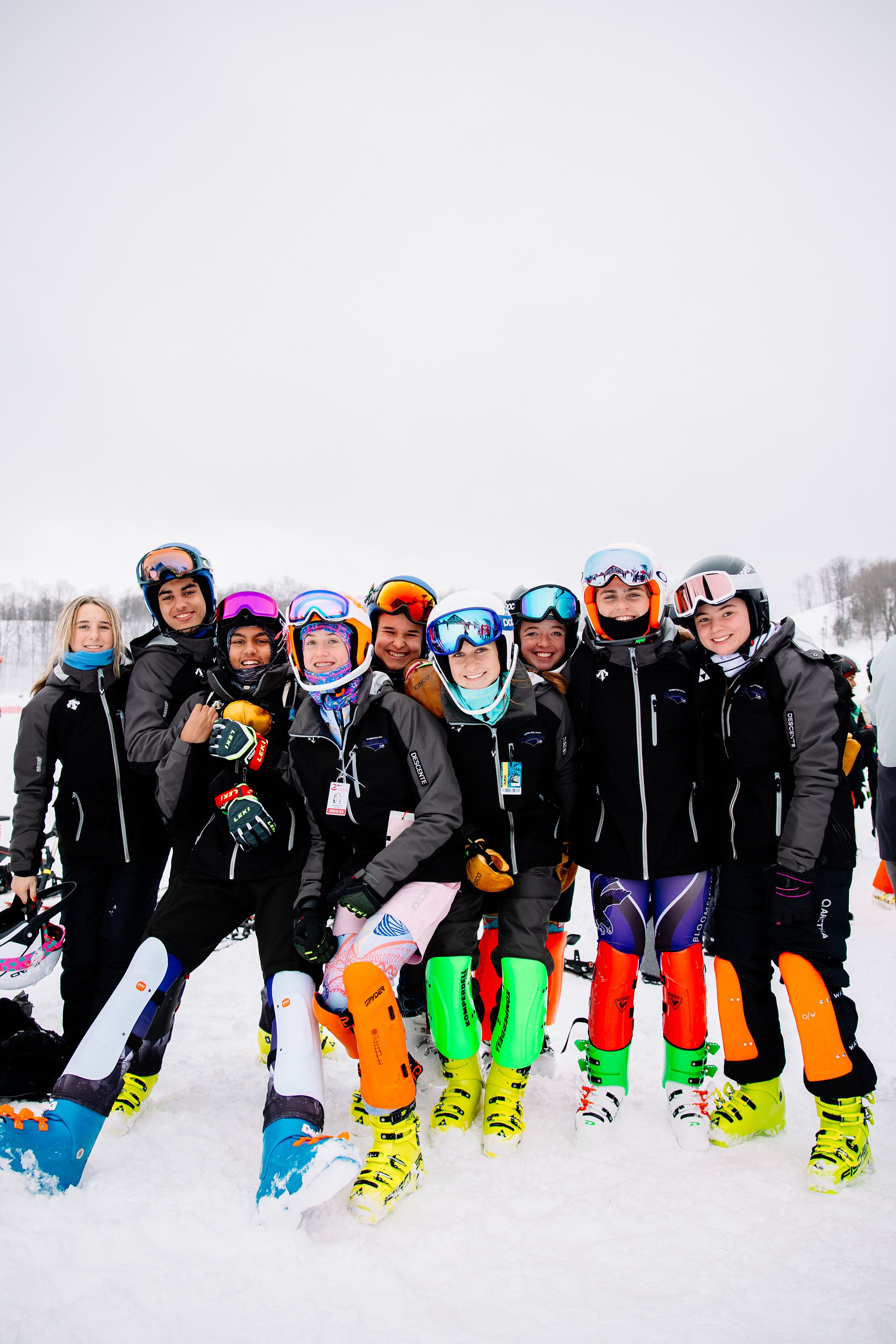 A group of ski racers smiling and posing at The Highlands