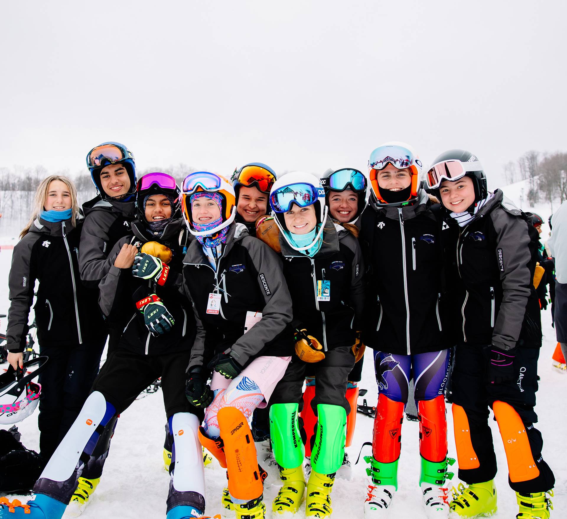 A group of ski racers smiling and posing at The Highlands