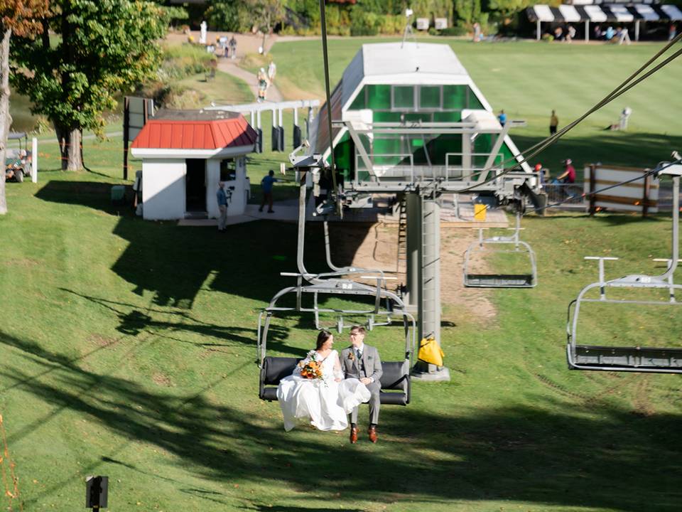 Bride and groom on a chairlift ride at The Highlands