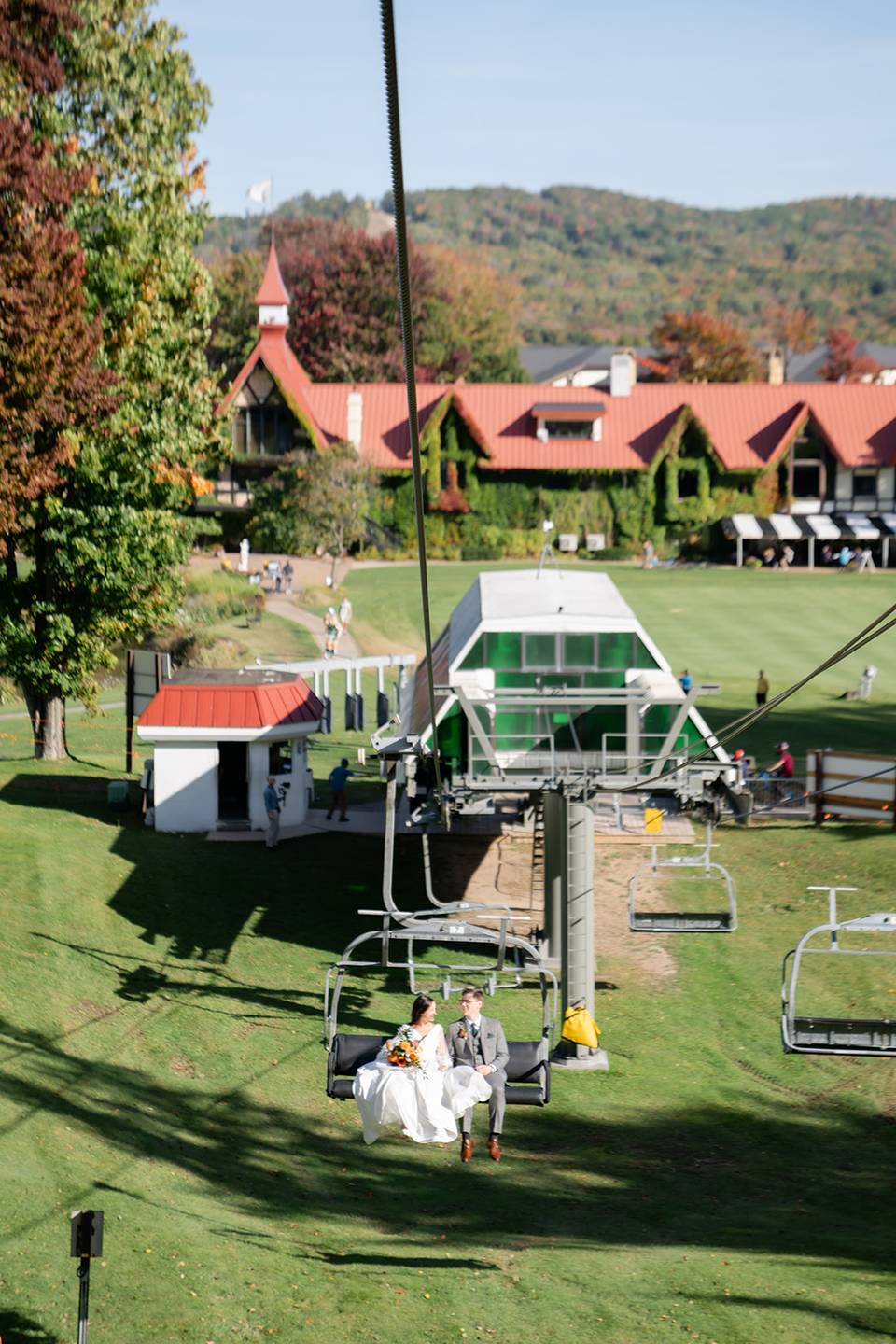 Bride and groom on a chairlift ride at The Highlands