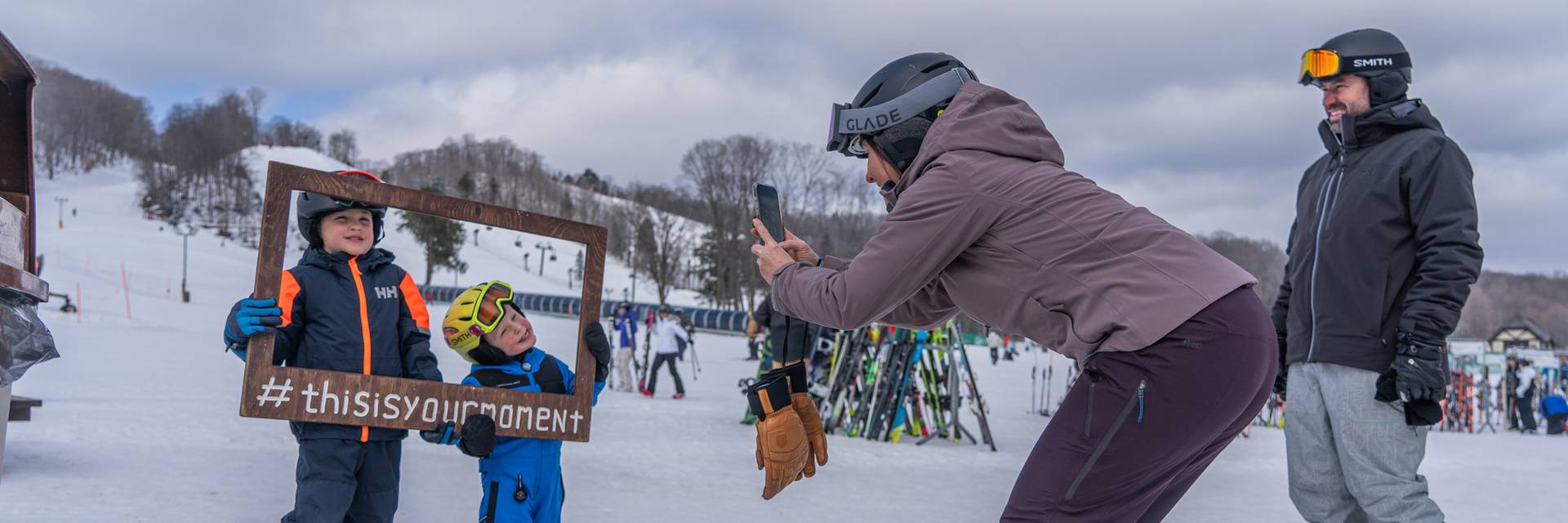 a family in ski gear posing at The Highlands