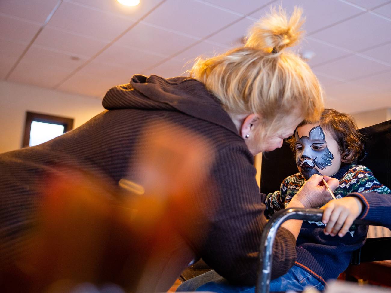 A boy getting his face painted at The Highlands