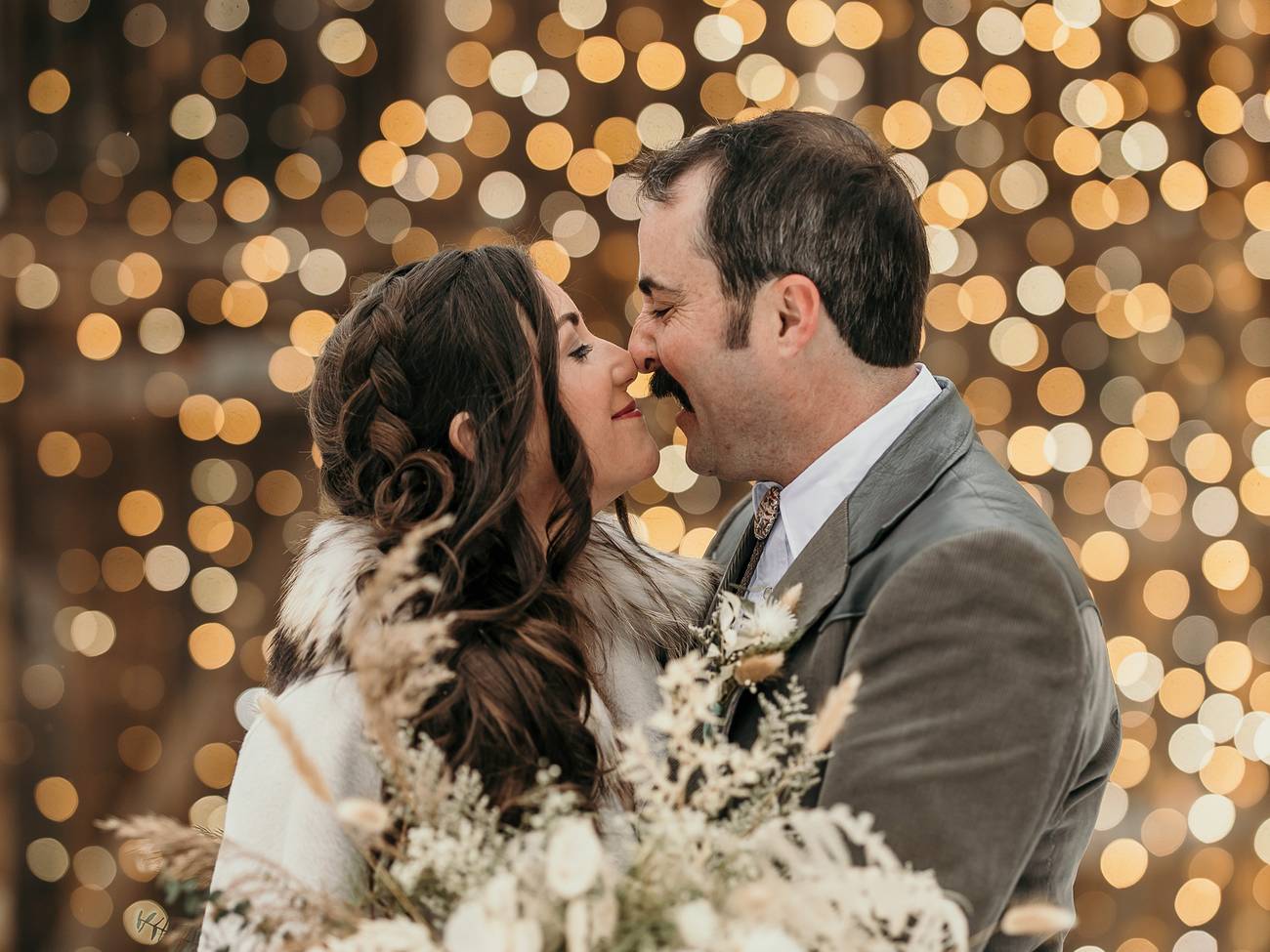 A bride and groom sharing a kiss at the yurt