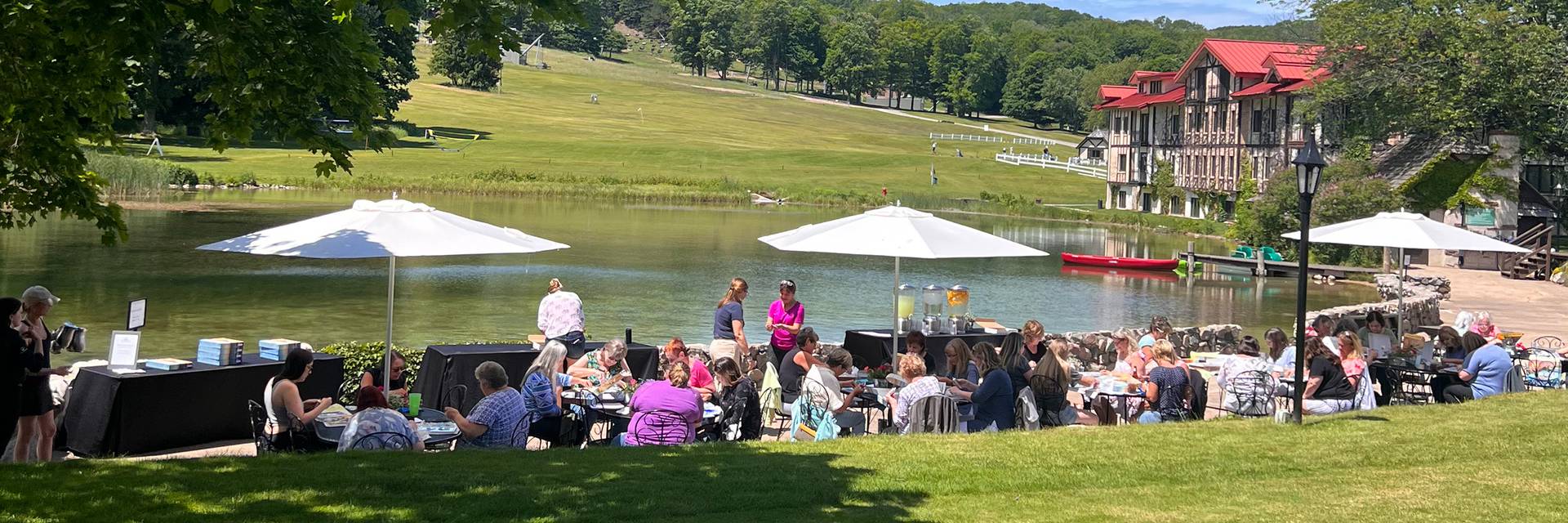 A group doing a craft on the lakeside patio