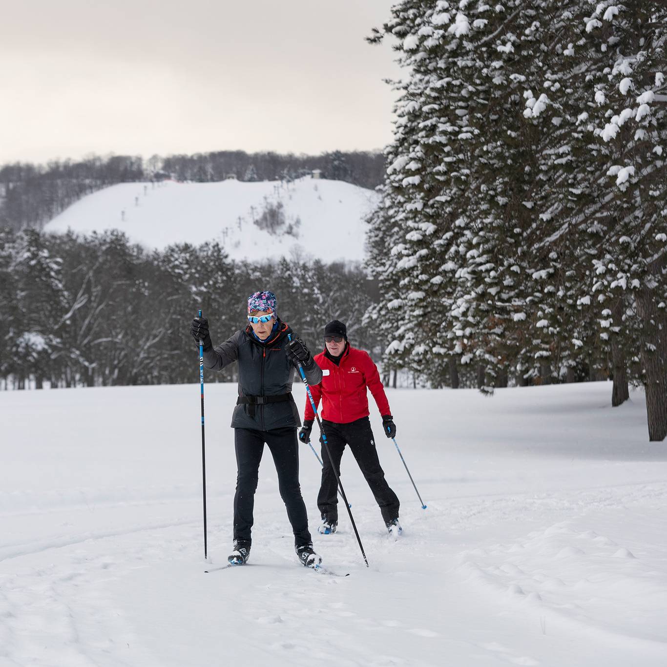 Two people on cross country skis on the nordic trails
