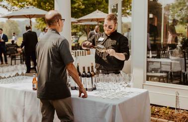 A man ordering a drink at a wedding at Country Club of Boyne