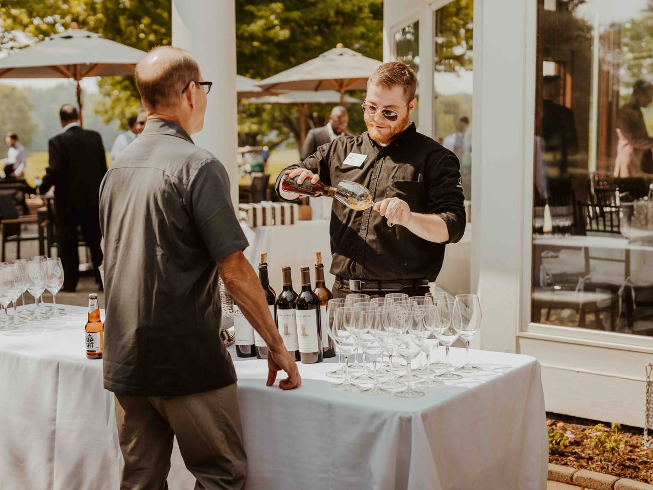 A man ordering a drink at a wedding at Country Club of Boyne