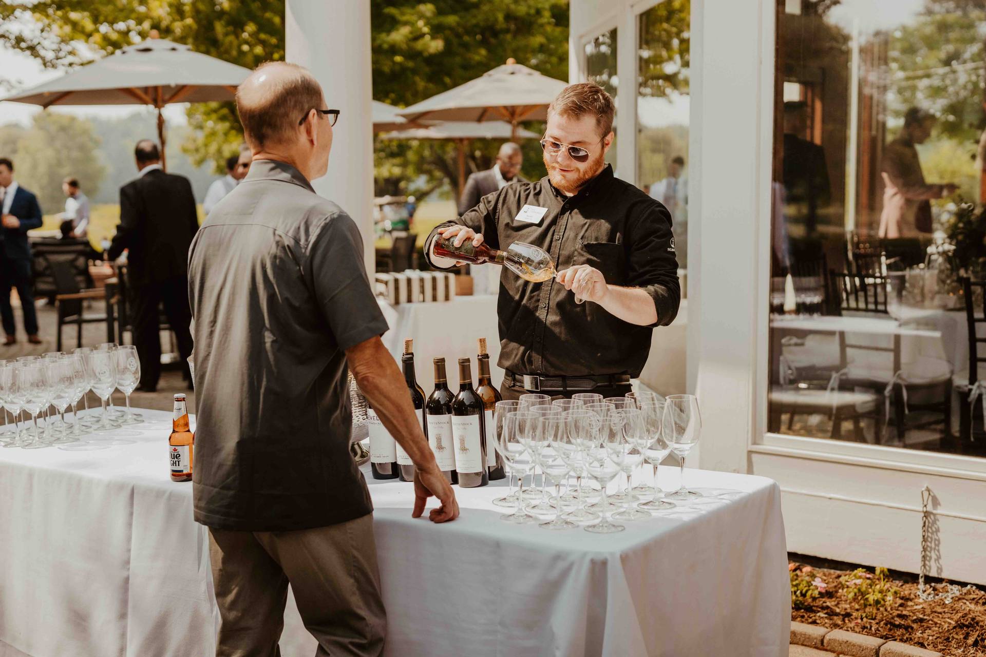 A man ordering a drink at a wedding at Country Club of Boyne