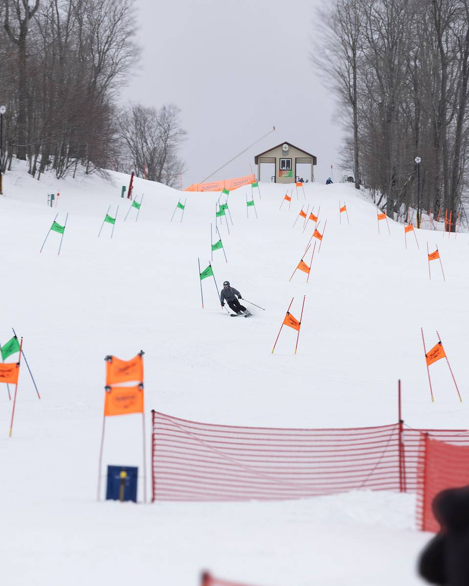 A skier racing on the NASTAR race course