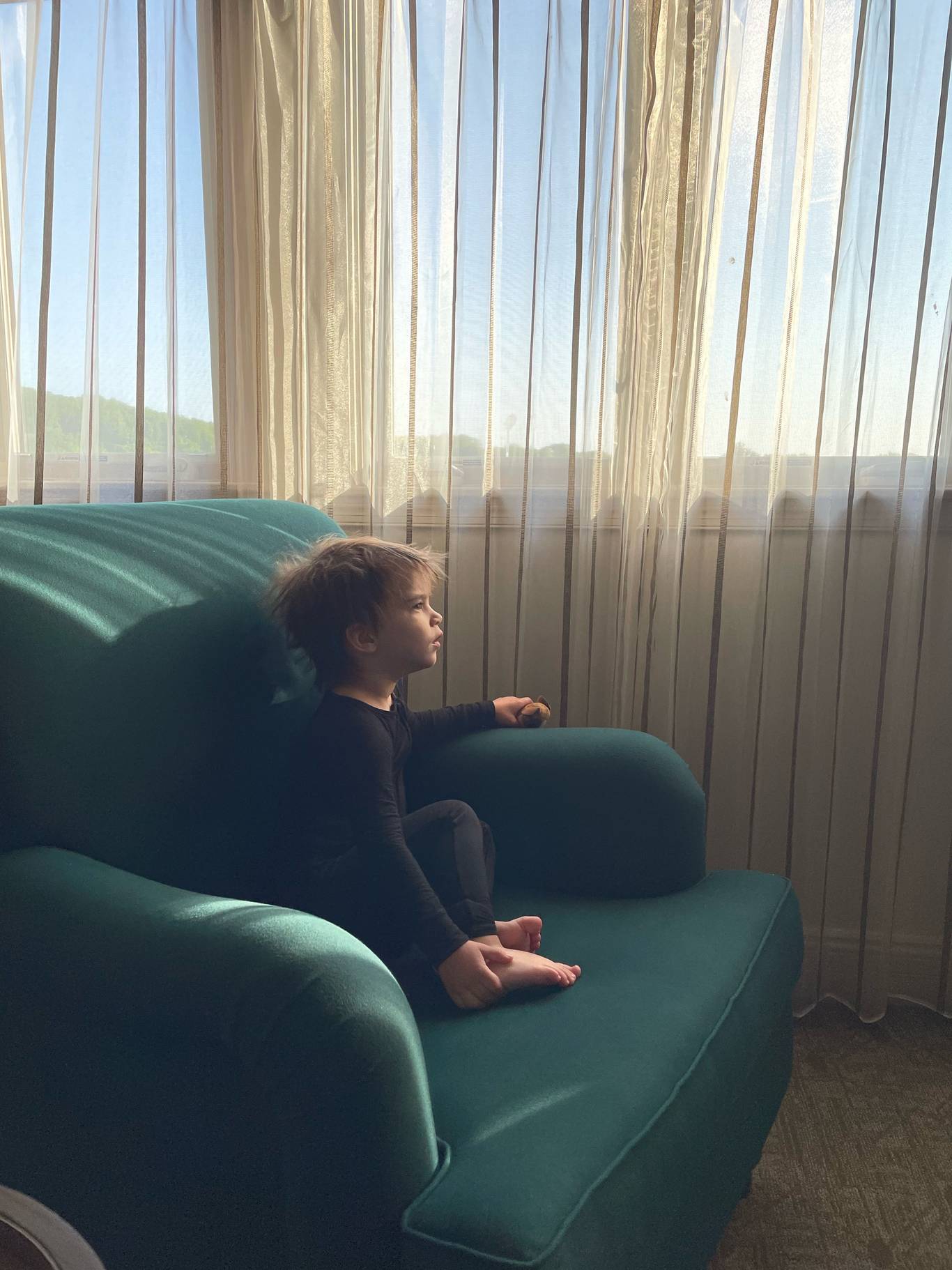 A child sitting on a chair in a Main Lodge room