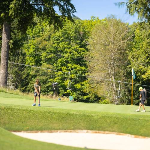 A dad and kids golfing Doon Brae