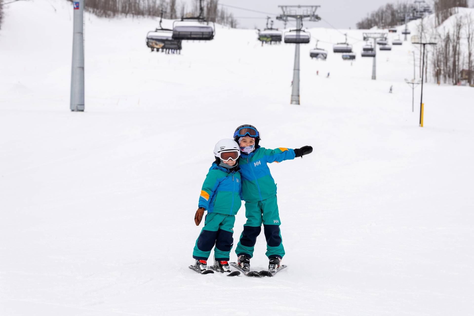 Two kids in ski gear posing at The Highlands