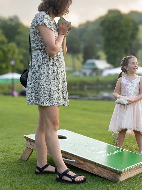 A woman and child playing lawn games