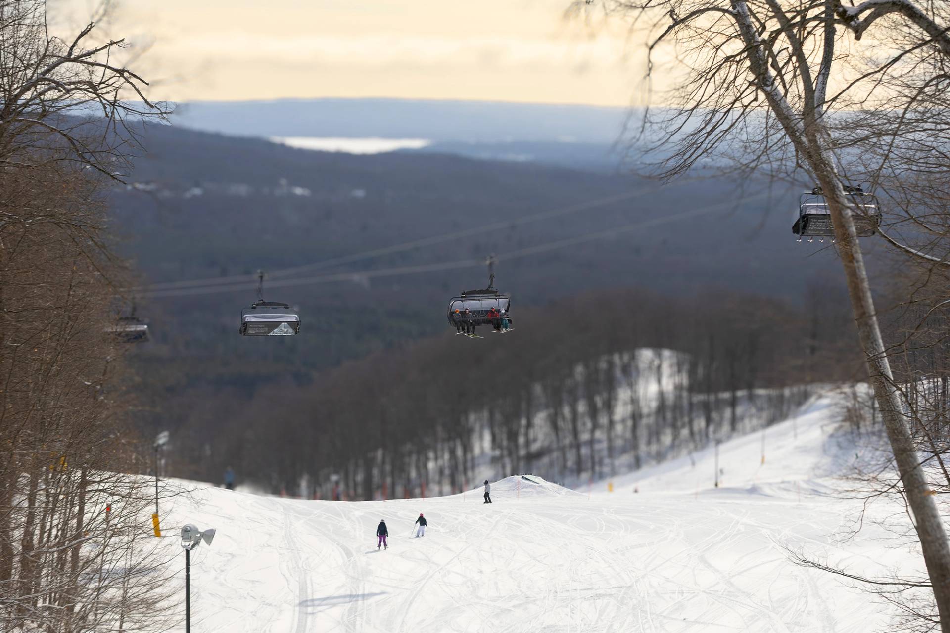 A drone shot of Camelot 6 with skiers sitting on it.