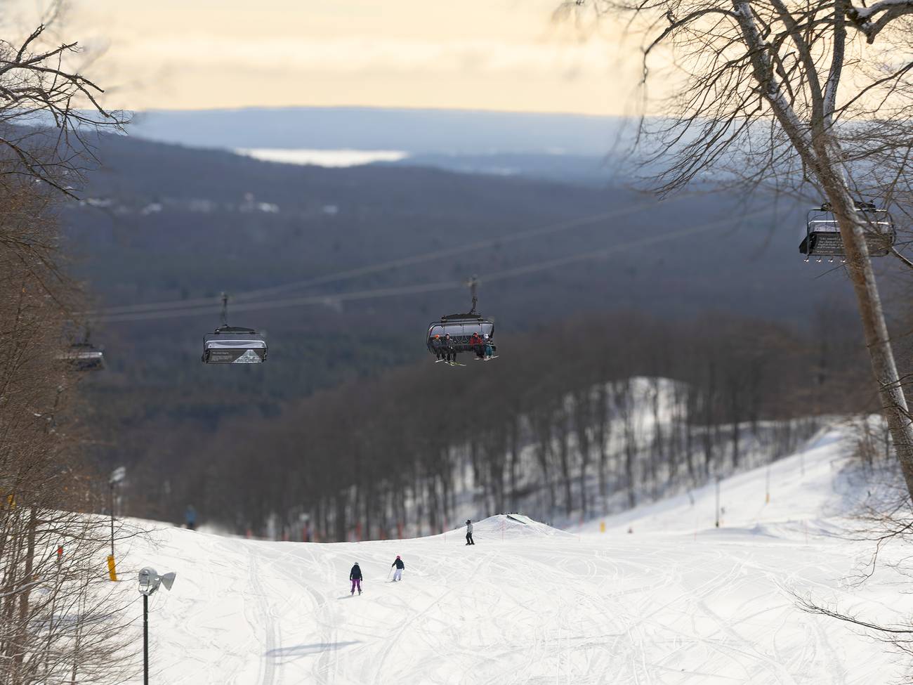 A drone shot of Camelot 6 with skiers sitting on it.
